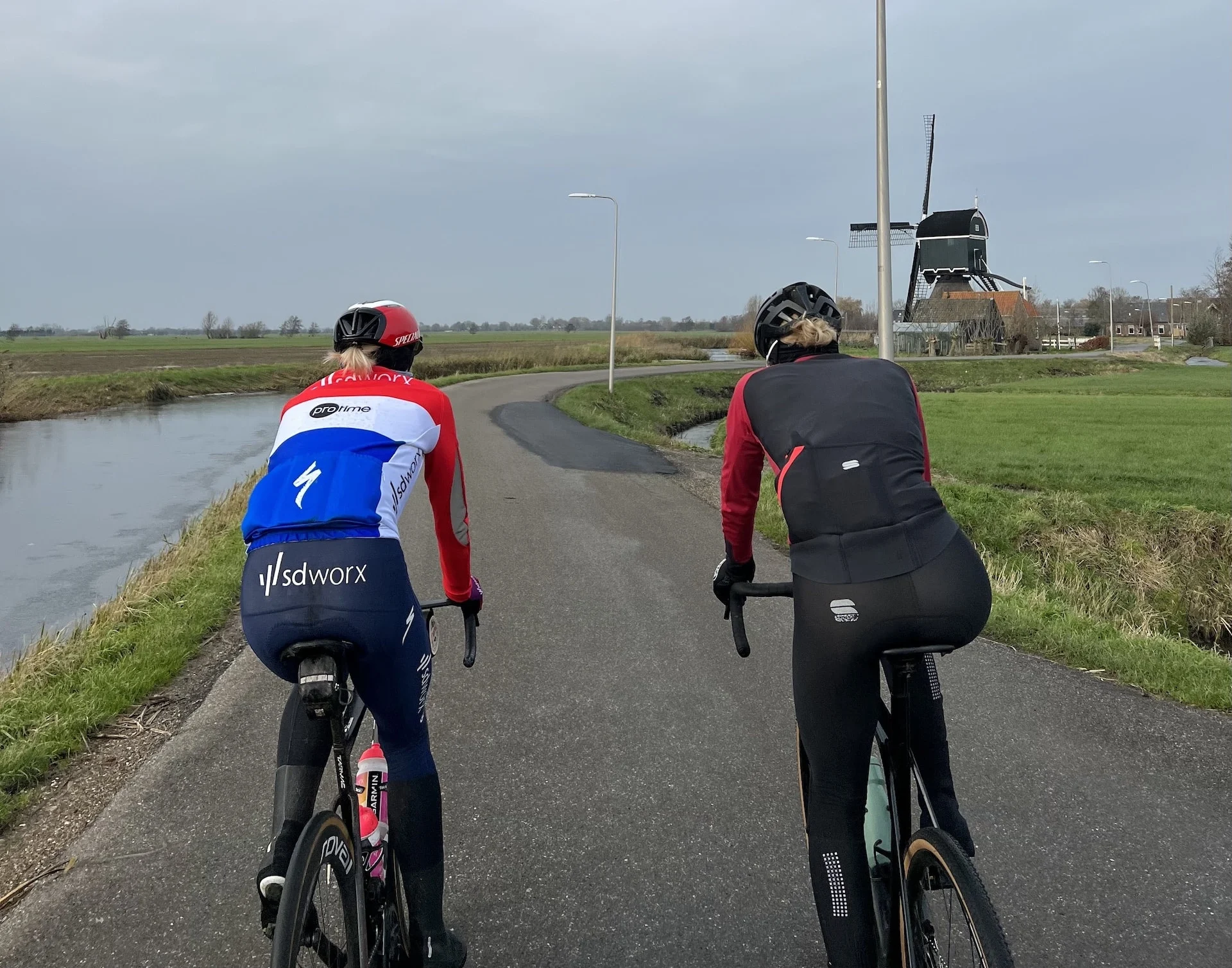 Demi Vollering and friend riding bikes on a road